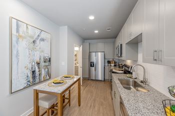 a kitchen with granite counter tops and a dining table